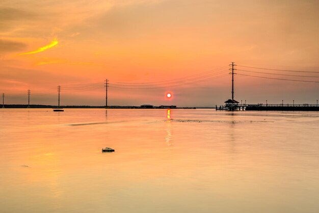 Scenic view of sea against orange sky