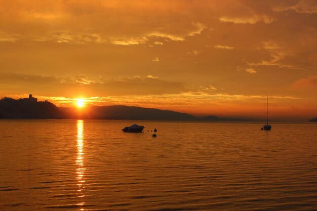 Scenic view of sea against orange sky