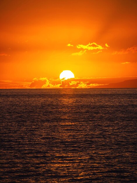 Scenic view of sea against orange sky