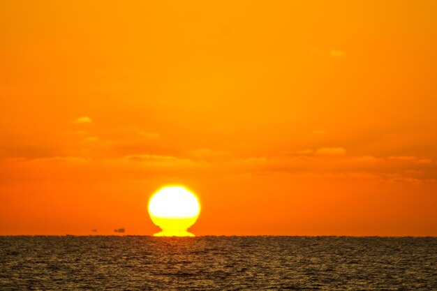 Scenic view of sea against orange sky