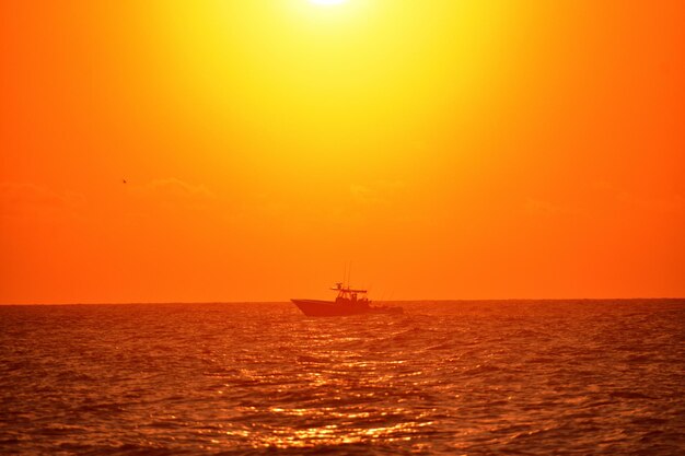 Scenic view of sea against orange sky