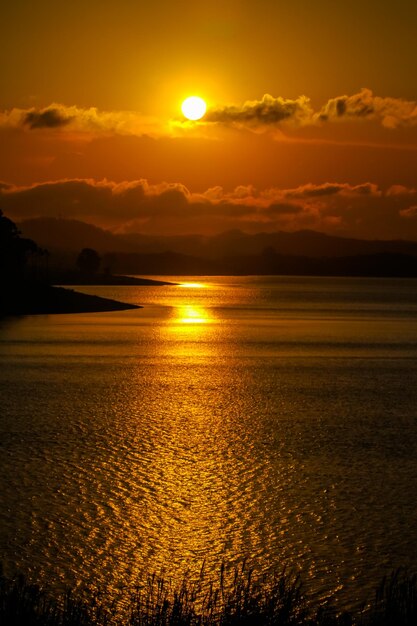 Scenic view of sea against orange sky