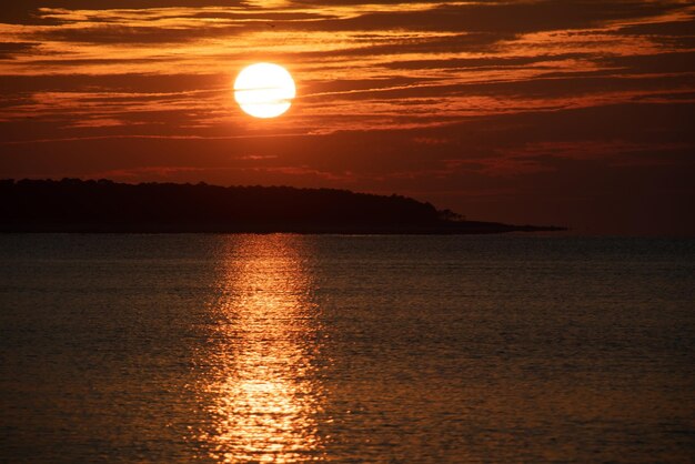 Scenic view of sea against orange sky