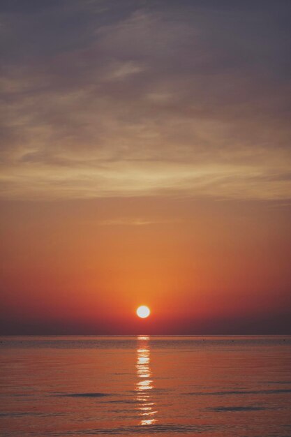 Scenic view of sea against orange sky