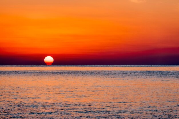 Scenic view of sea against orange sky