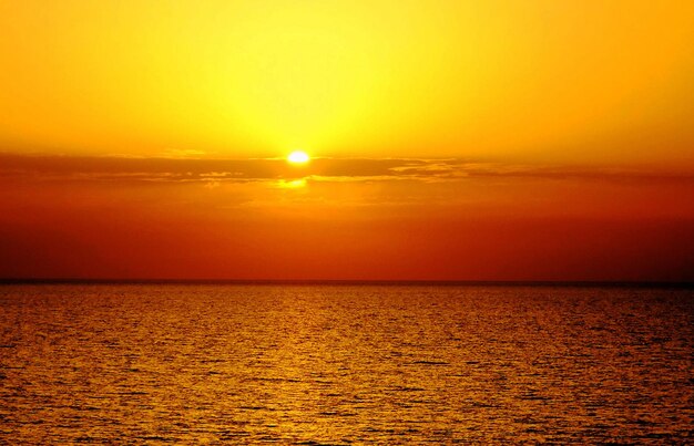 Scenic view of sea against orange sky