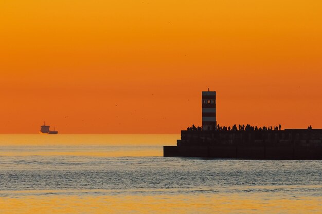 Scenic view of sea against orange sky