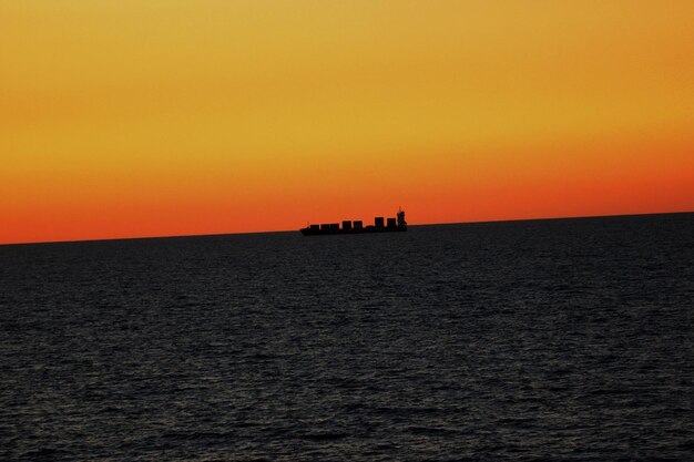 Scenic view of sea against orange sky