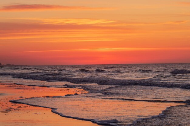 Scenic view of sea against orange sky