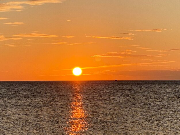 Scenic view of sea against orange sky