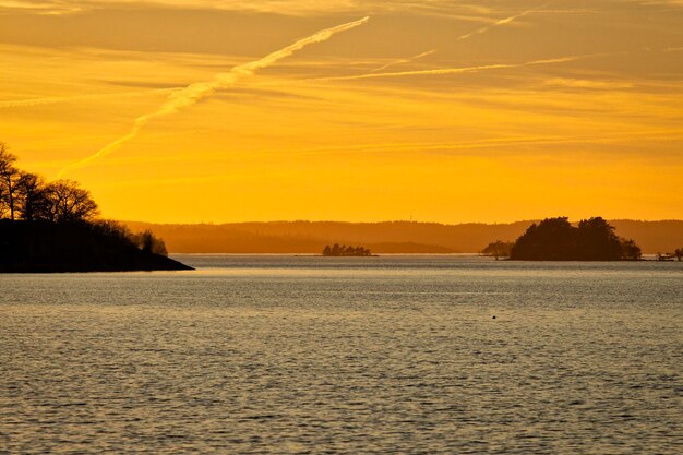 Scenic view of sea against orange sky