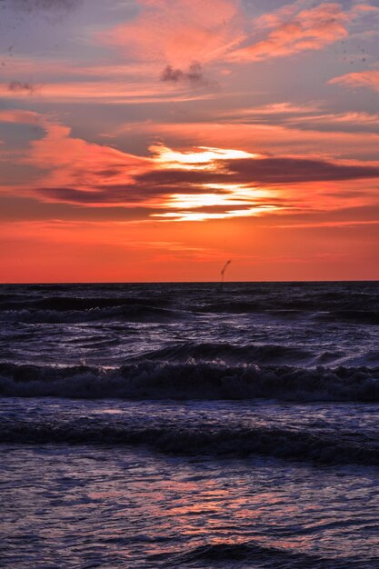 Scenic view of sea against orange sky