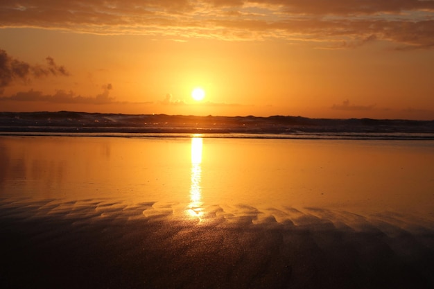 scenic view of sea against orange sky