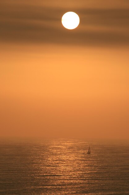 Scenic view of sea against orange sky