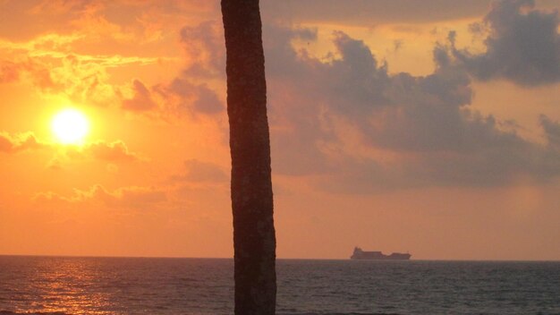 Scenic view of sea against orange sky