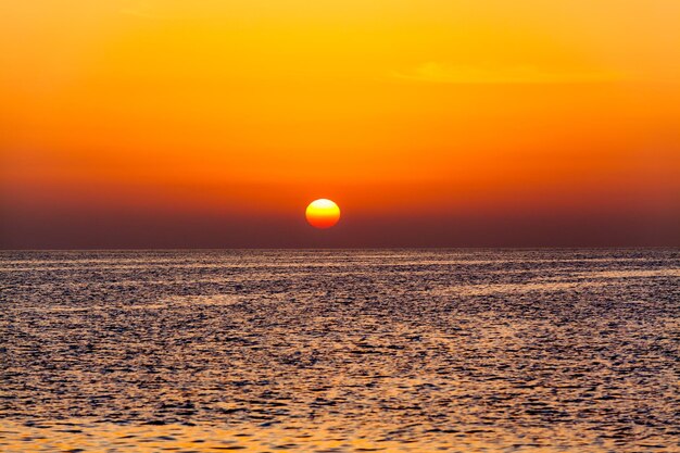 Scenic view of sea against orange sky