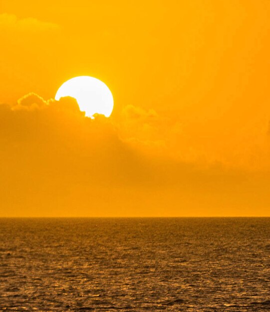 Scenic view of sea against orange sky