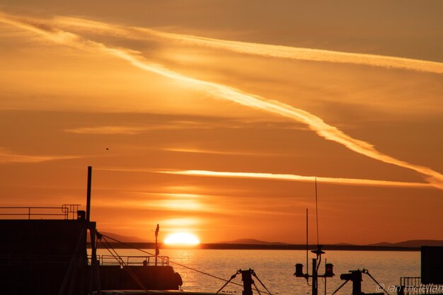 Scenic view of sea against orange sky