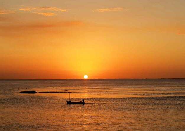 Scenic view of sea against orange sky