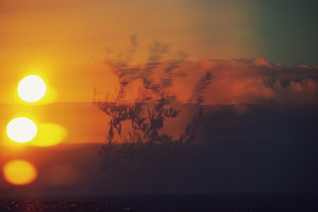 Scenic view of sea against orange sky