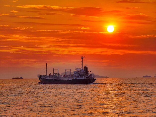 Scenic view of sea against orange sky