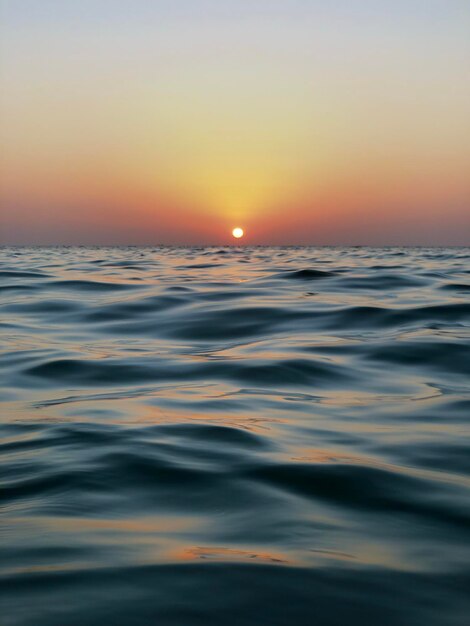 Scenic view of sea against orange sky