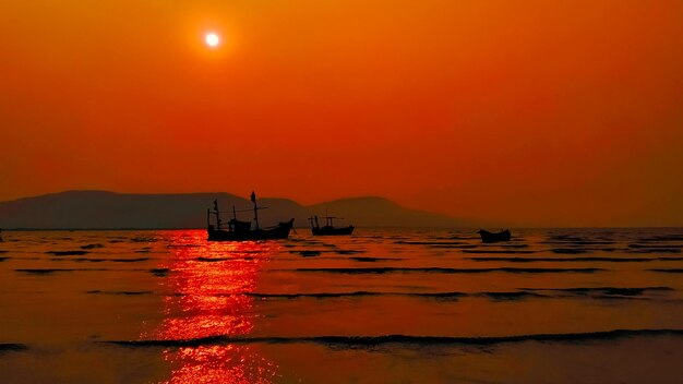 Scenic view of sea against orange sky