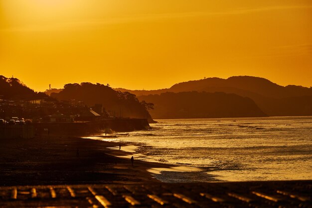 Scenic view of sea against orange skyduring sunrise