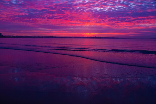 Scenic view of sea against romantic sky at sunrise