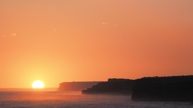 Scenic view of sea against romantic sky at sunset