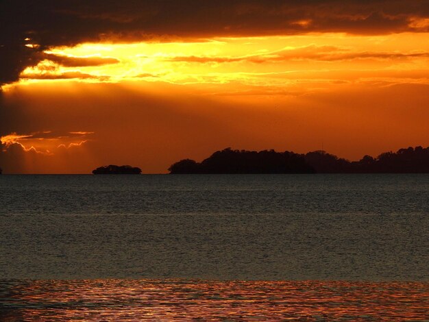 Scenic view of sea against romantic sky at sunset