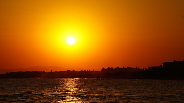 Scenic view of sea against romantic sky at sunset