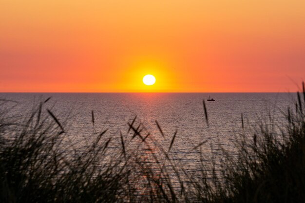 Scenic view of sea against romantic sky at sunset