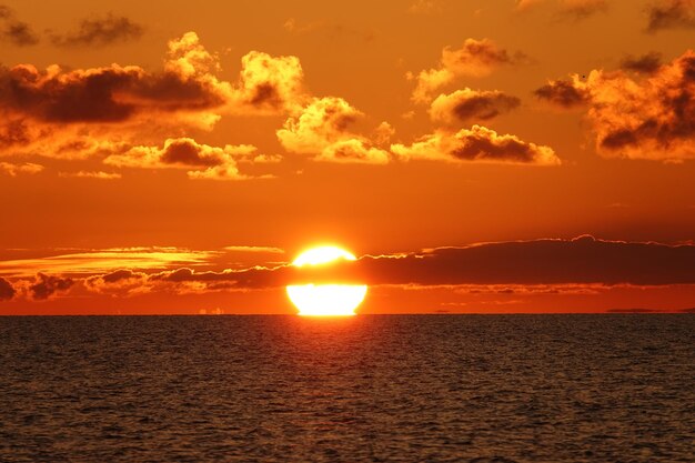 Scenic view of sea against romantic sky at sunset