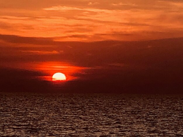 Scenic view of sea against romantic sky at sunset