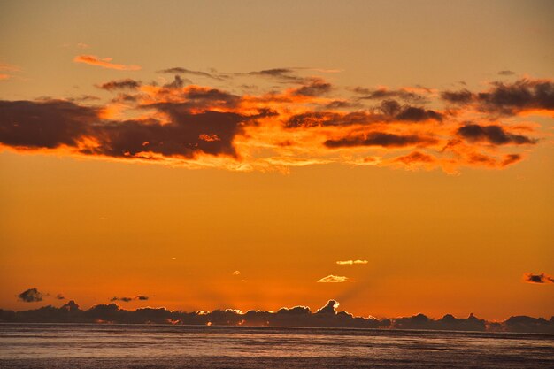 Scenic view of sea against romantic sky at sunset