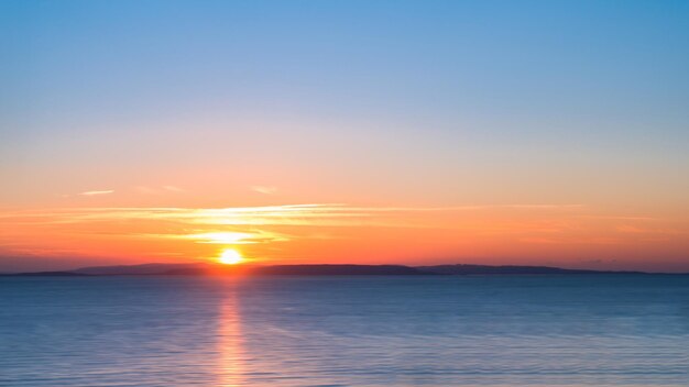 Scenic view of sea against romantic sky at sunset