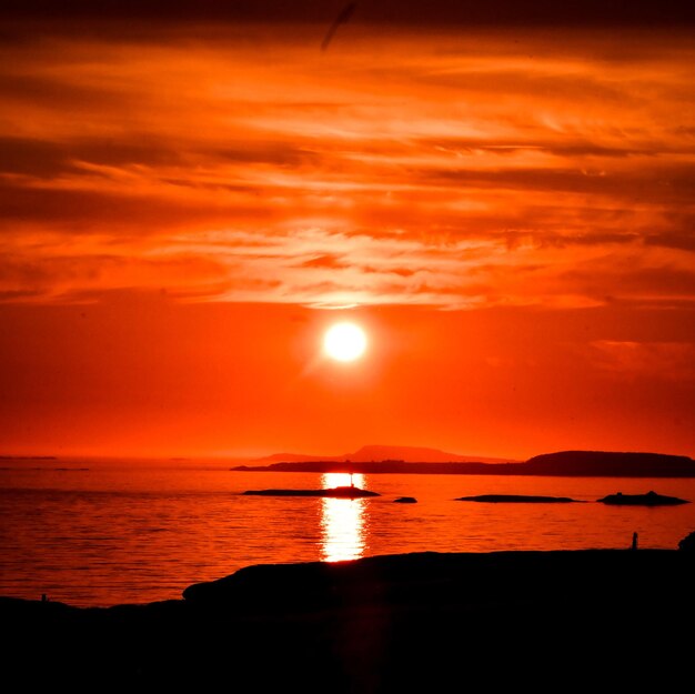 Scenic view of sea against romantic sky at sunset