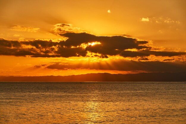 Scenic view of sea against romantic sky at sunset