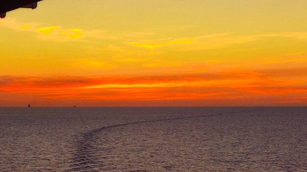 Scenic view of sea against romantic sky at sunset