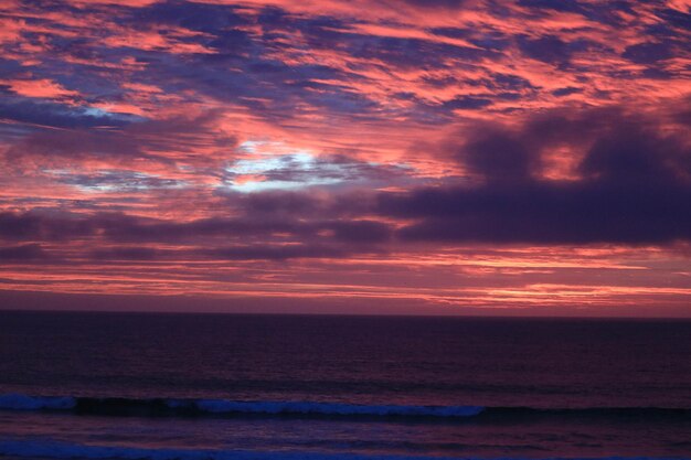 Scenic view of sea against romantic sky at sunset