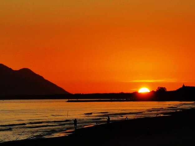 Scenic view of sea against romantic sky at sunset