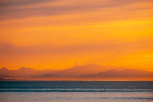 Scenic view of sea against romantic sky at sunset