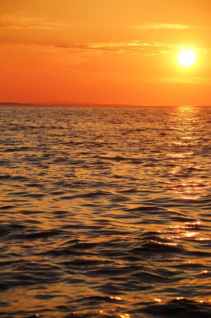 Scenic view of sea against romantic sky at sunset