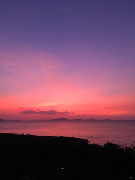 Scenic view of sea against romantic sky at sunset