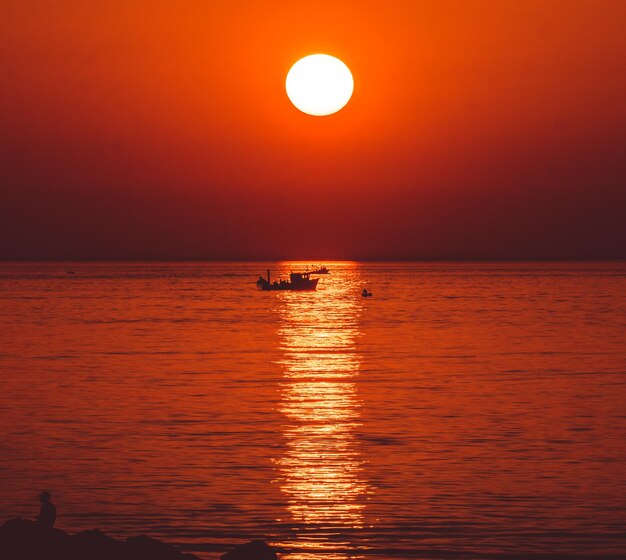 Scenic view of sea against romantic sky at sunset