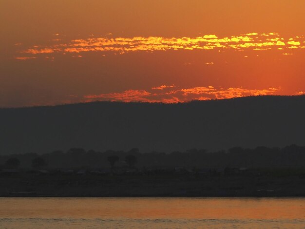 Scenic view of sea against romantic sky at sunset