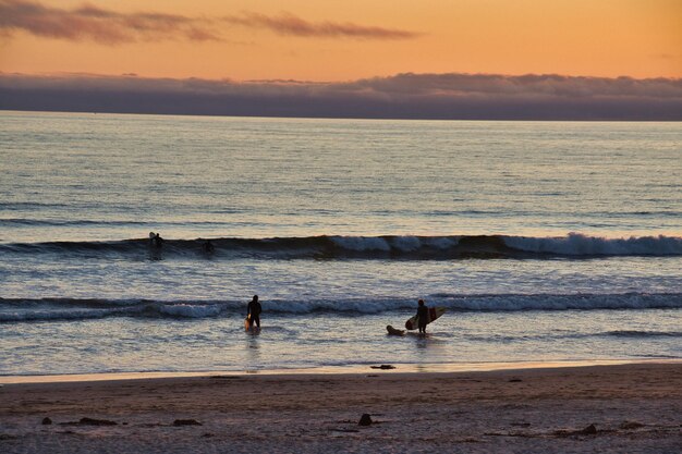 Photo scenic view of sea against sky during sunset