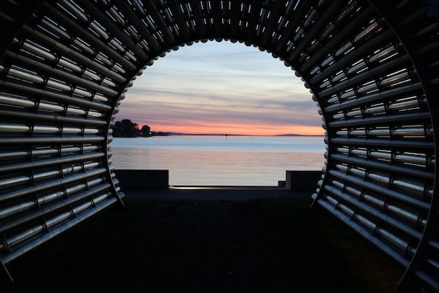 Photo scenic view of sea against sky during sunset