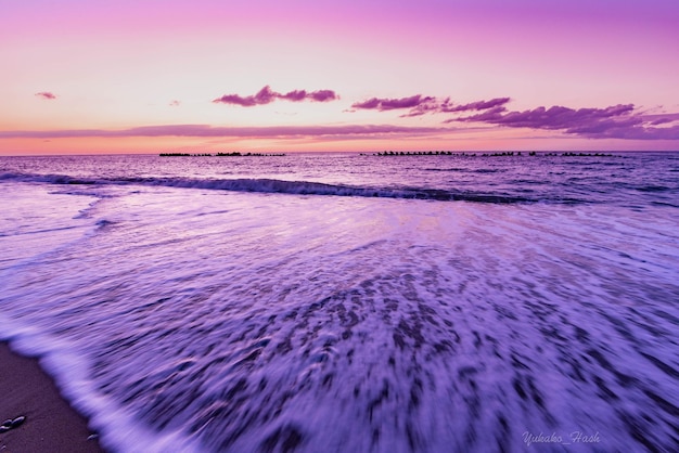 Photo scenic view of sea against sky during sunset